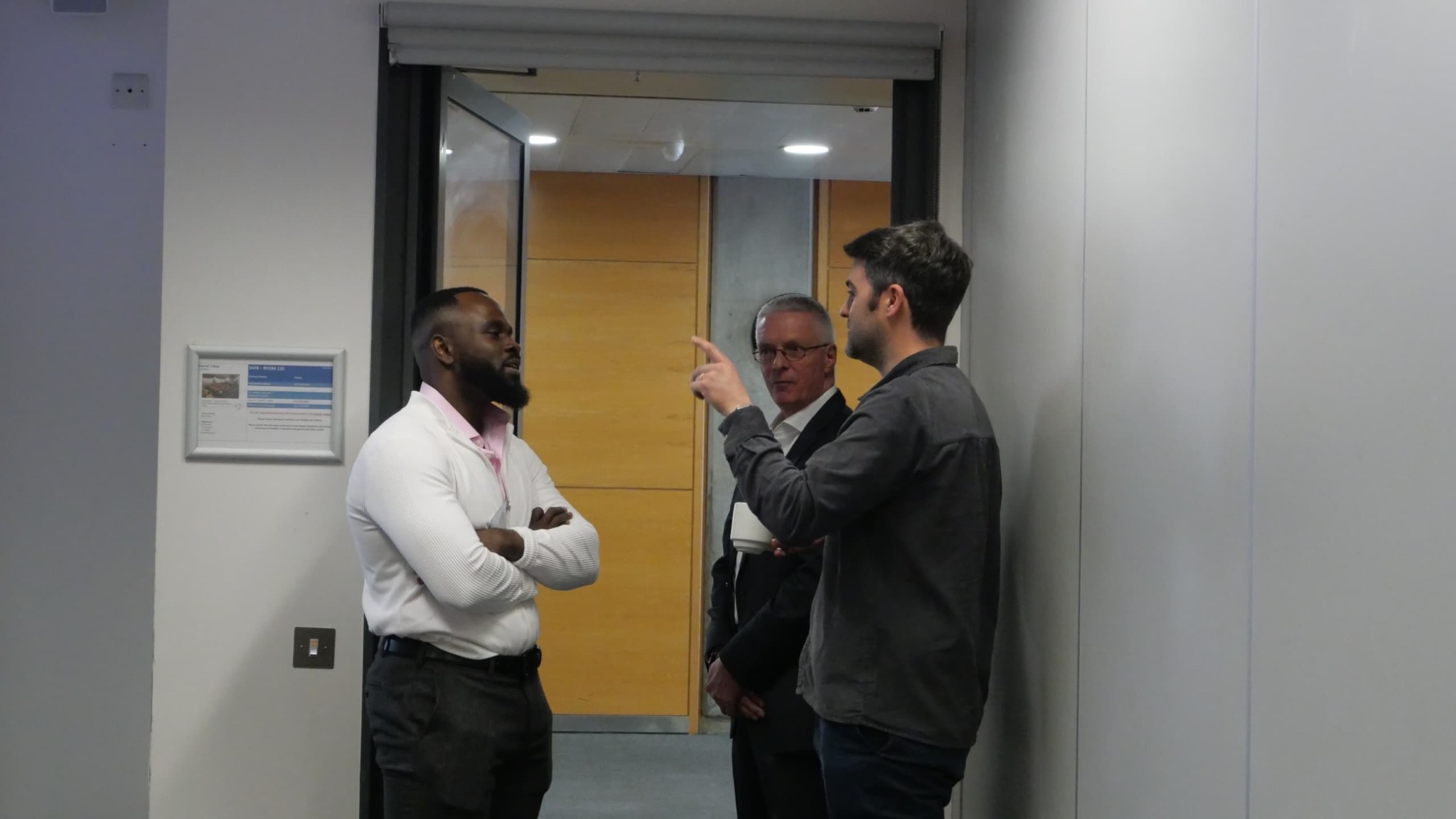 Emmanuel Igbinovia speaking with colleagues